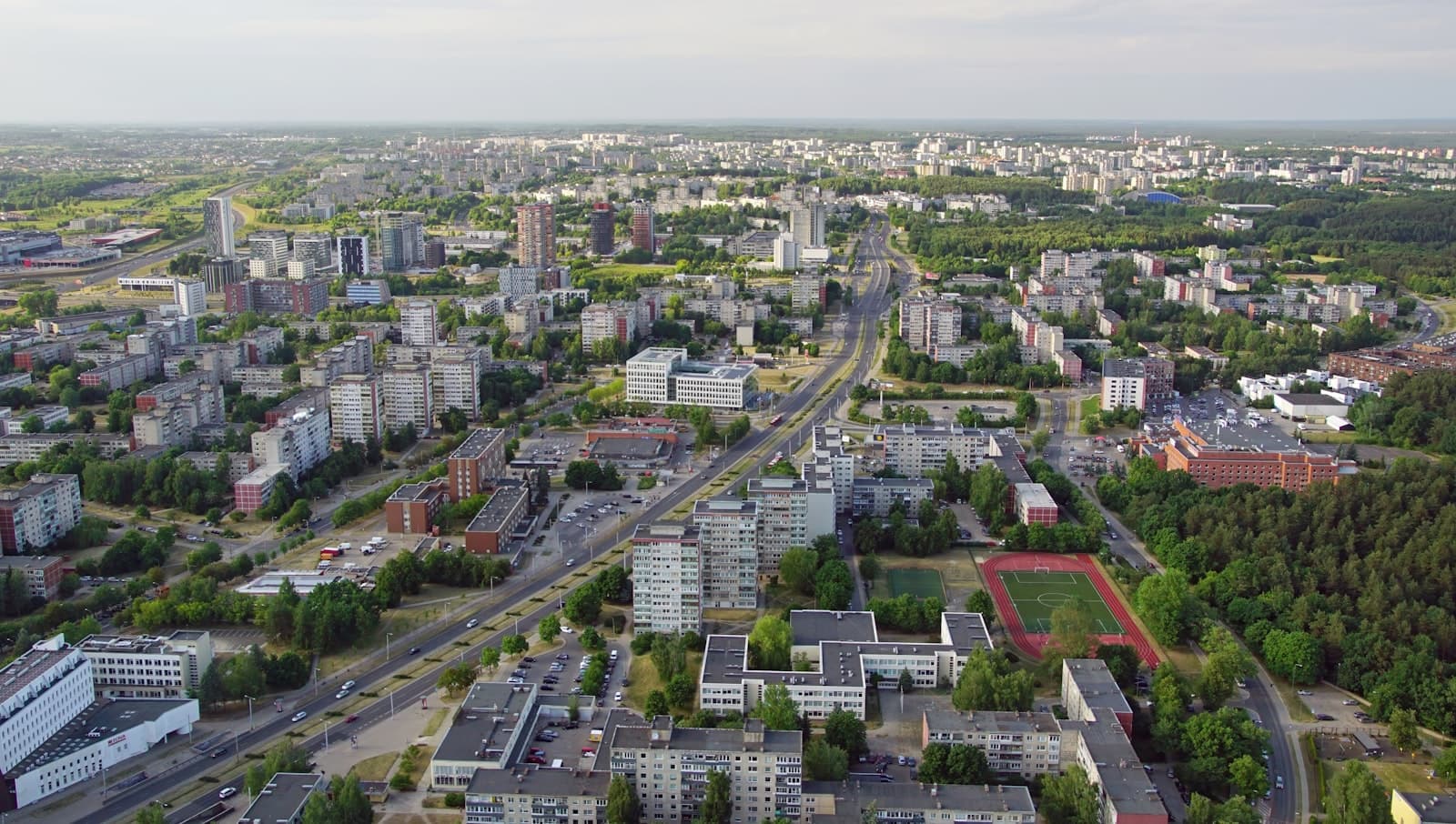 Aerial view of a growing Baltic city with apartment blocks and green space