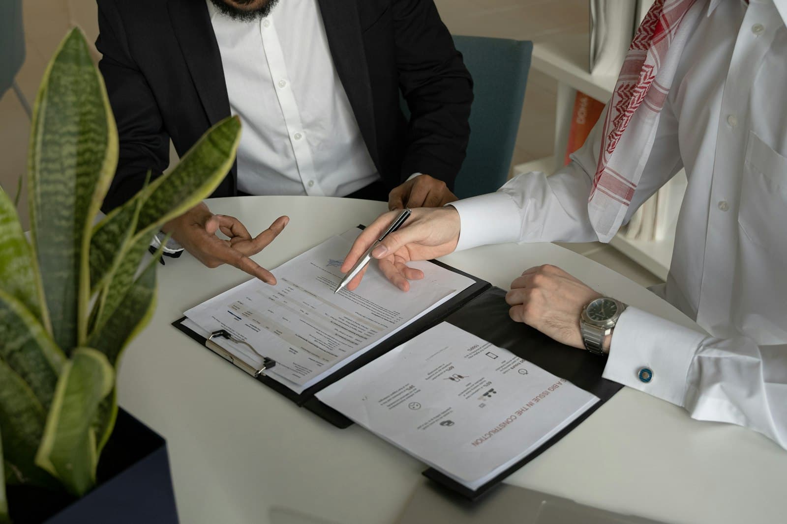 Two people reviewing paperwork at a desk