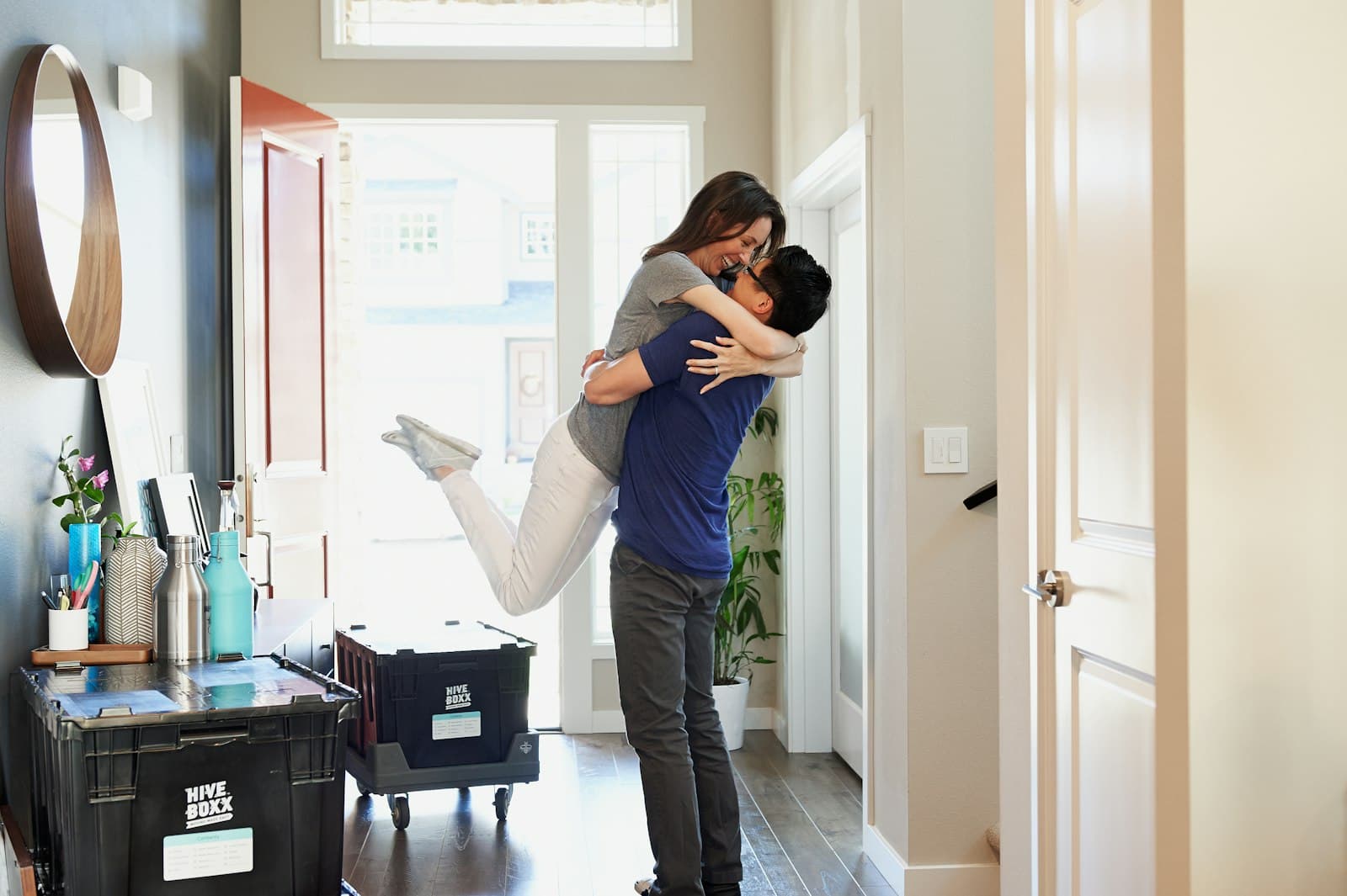 A couple embracing in the doorway of their new home