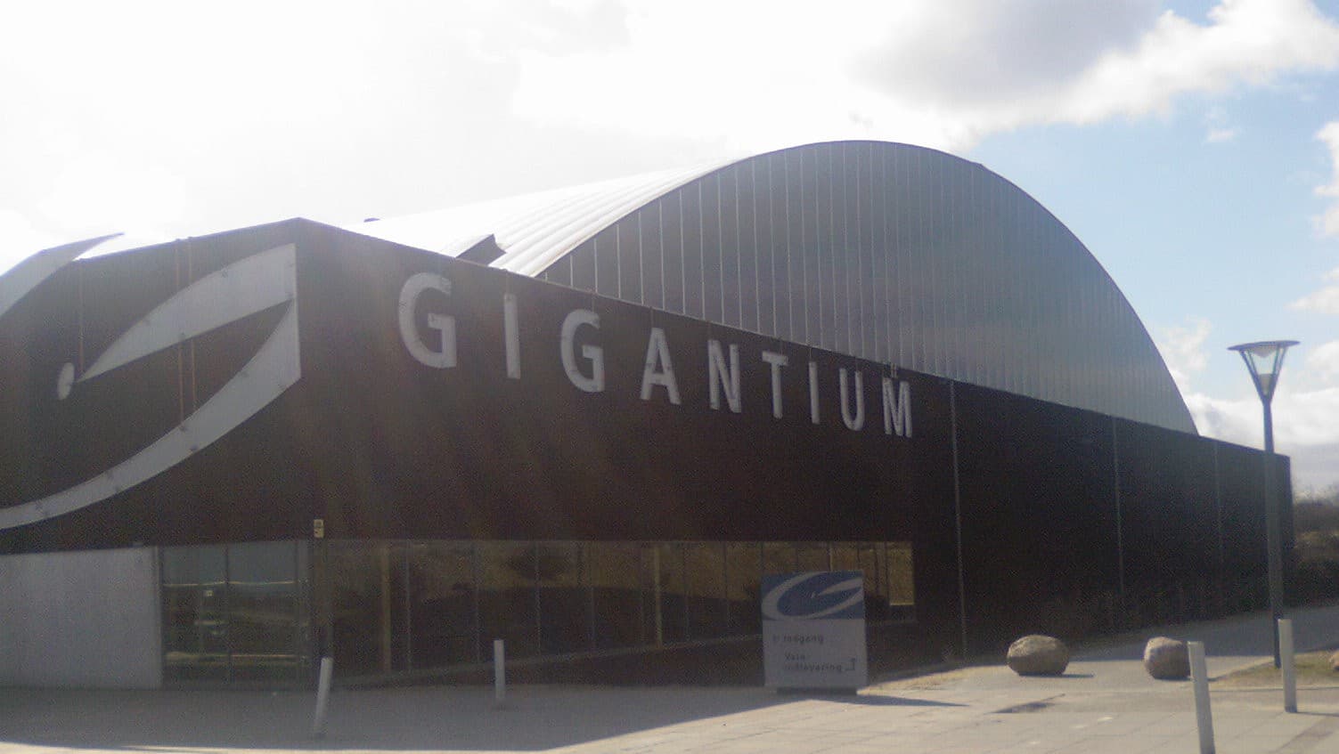 The dark curved shell of the Gigantium arena in Aalborg Øst.