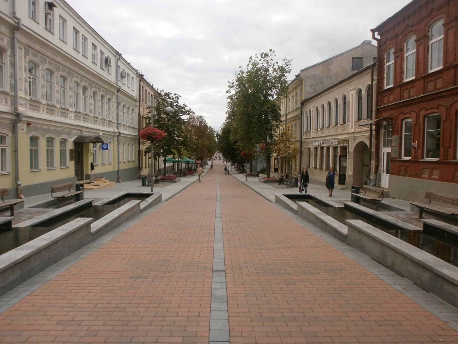 The pedestrianised Rīgas iela running through the red brick historical centre of Daugavpils, Latvia, lined with 19th century facades.