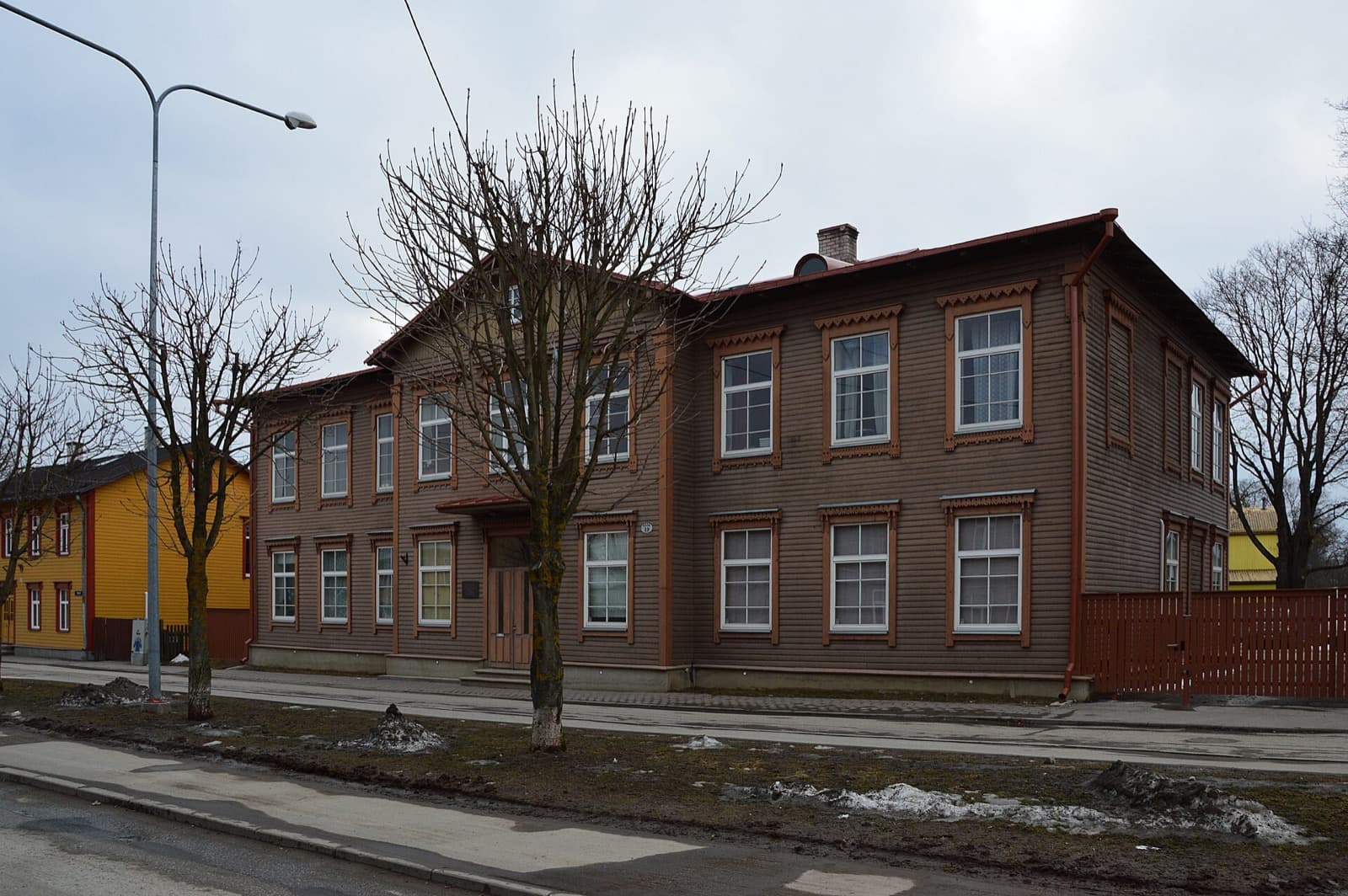 Ornate wooden houses on a residential street in Karlova, Tartu's wooden heritage district.