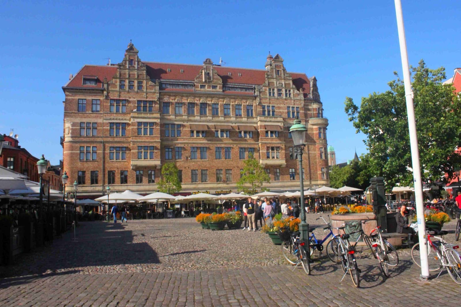 The half-timbered houses and pavement terraces of Lilla Torg in the old town of Malmö, Sweden.