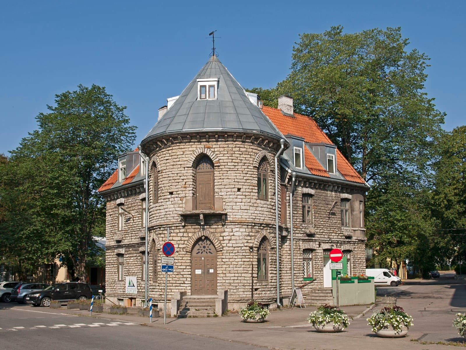 The historic stone former post office among mature trees in Nõmme.