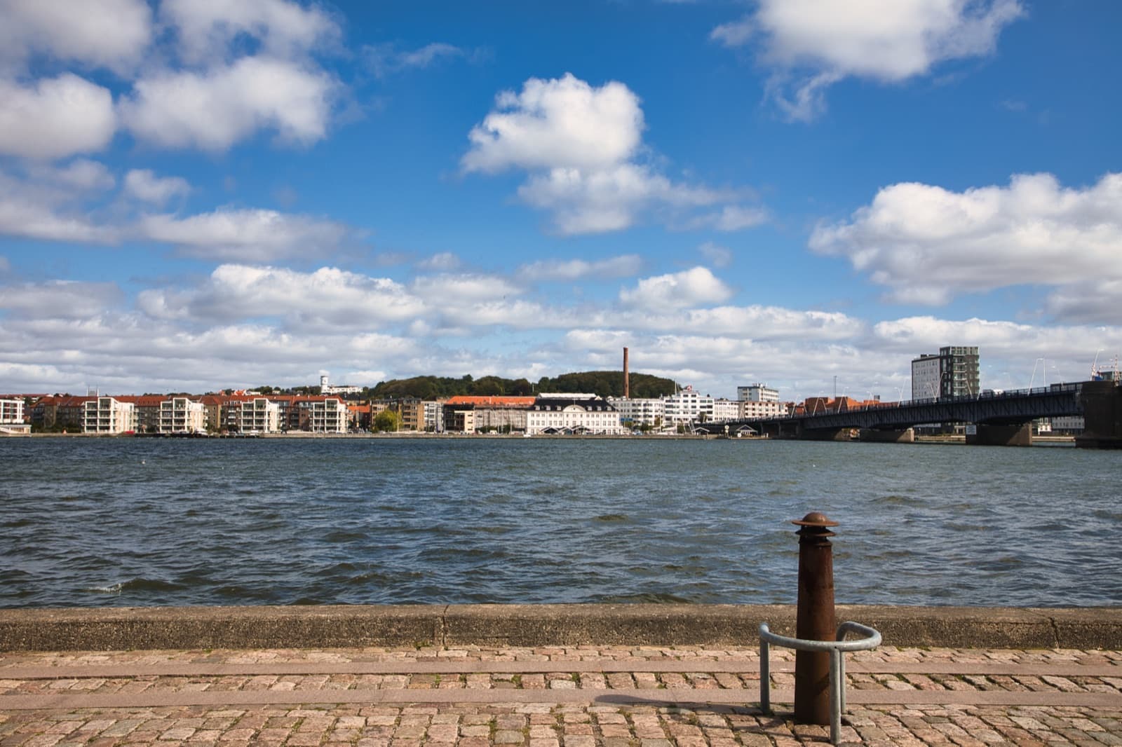 The Nørresundby waterfront on the north bank of the Limfjord seen across the water, with the Limfjord bridge on the right, opposite Aalborg, Denmark.