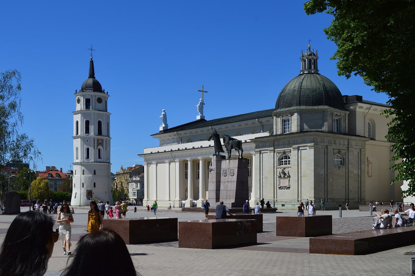 Cathedral Square in Senamiestis with the white bell tower, the neoclassical Vilnius Cathedral, and the Grand Duke Gediminas monument.