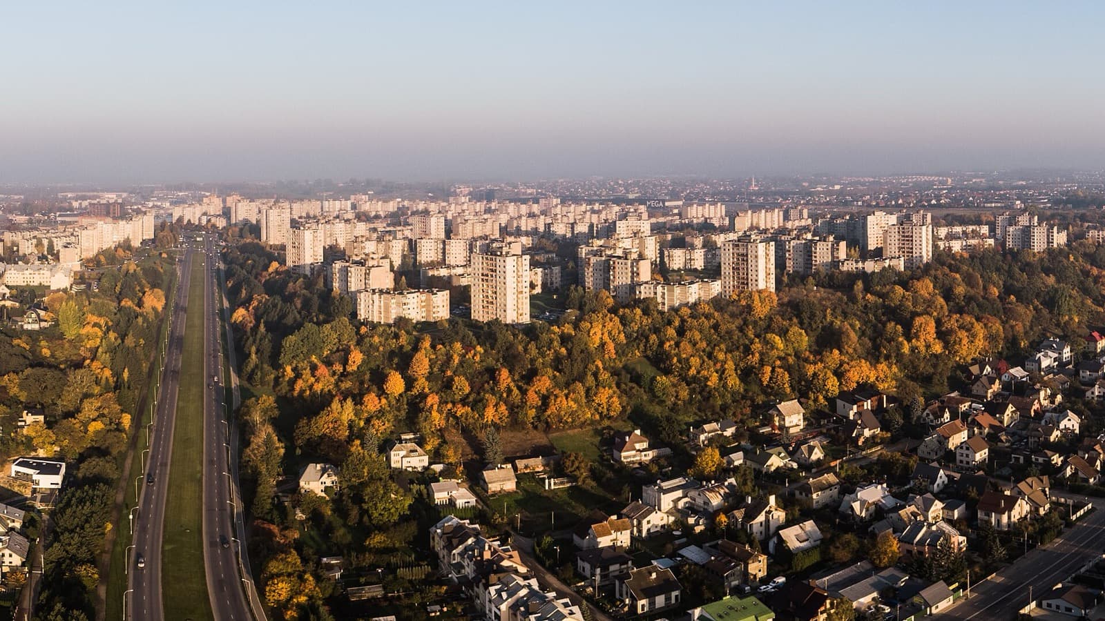 An aerial view over the Soviet-era apartment blocks and autumn greenery of Šilainiai, Kaunas.