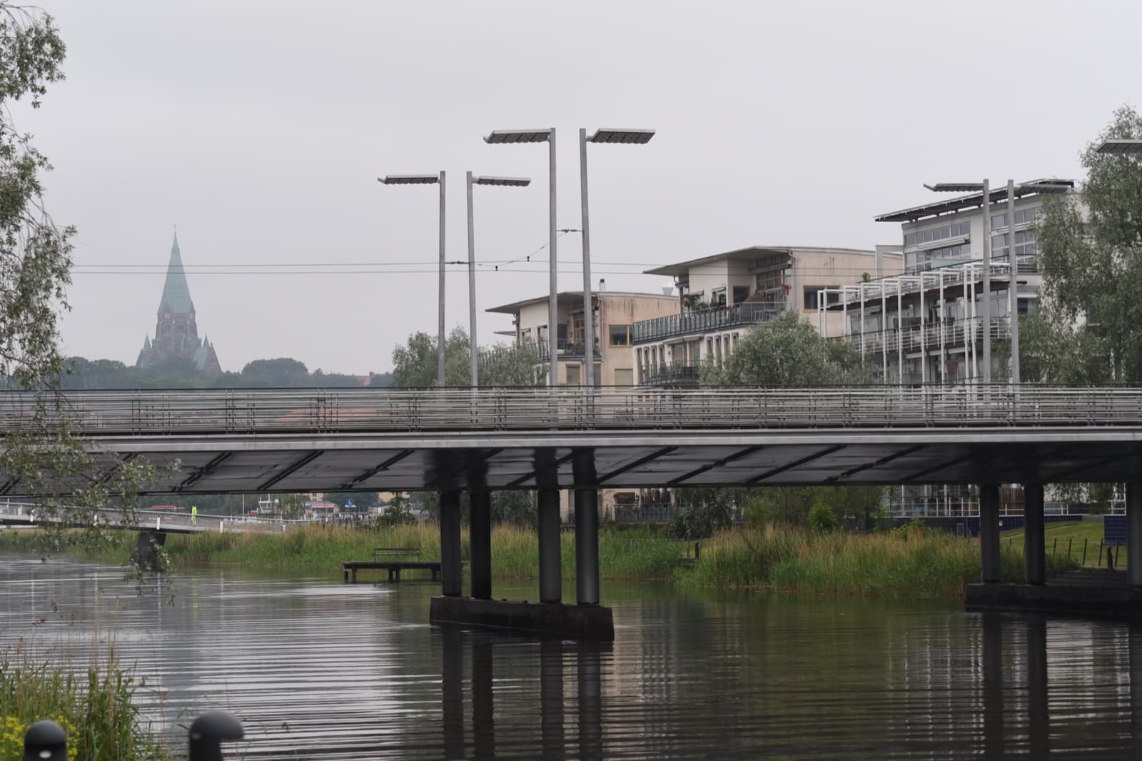 A bridge on Lugnets allé over the Sickla canal, lined by waterfront apartment blocks in Hammarby Sjöstad, Stockholm.