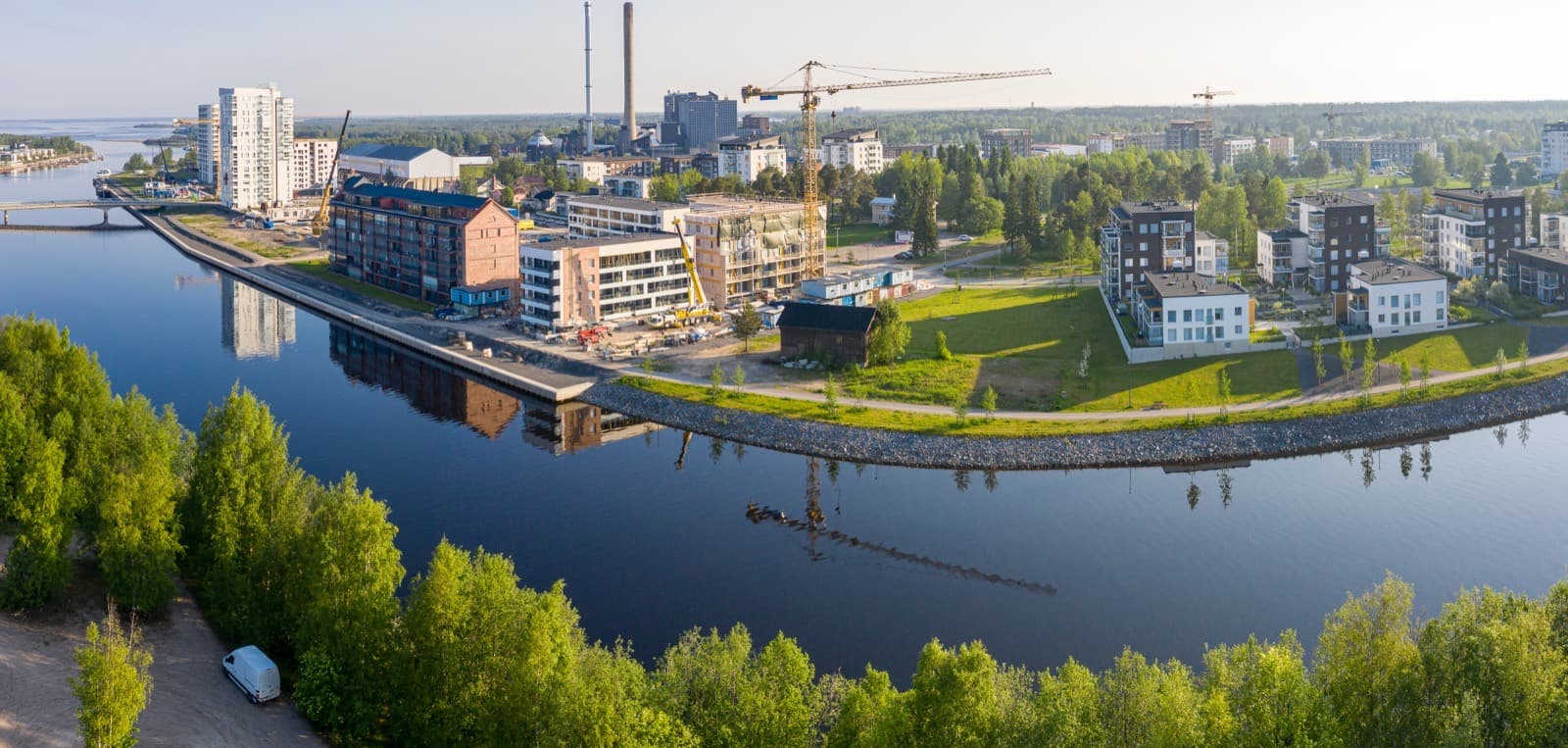 Early morning over the Toppilansalmi strait in Toppila, Oulu, with the old brick mill, new waterfront flats and the sea beyond.