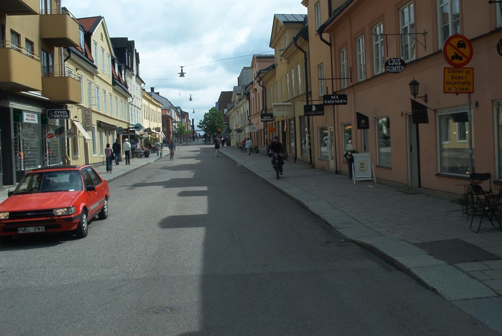 A stretch of Svartbäcksgatan in Uppsala that keeps the old small-town character, with low older buildings lining the street.