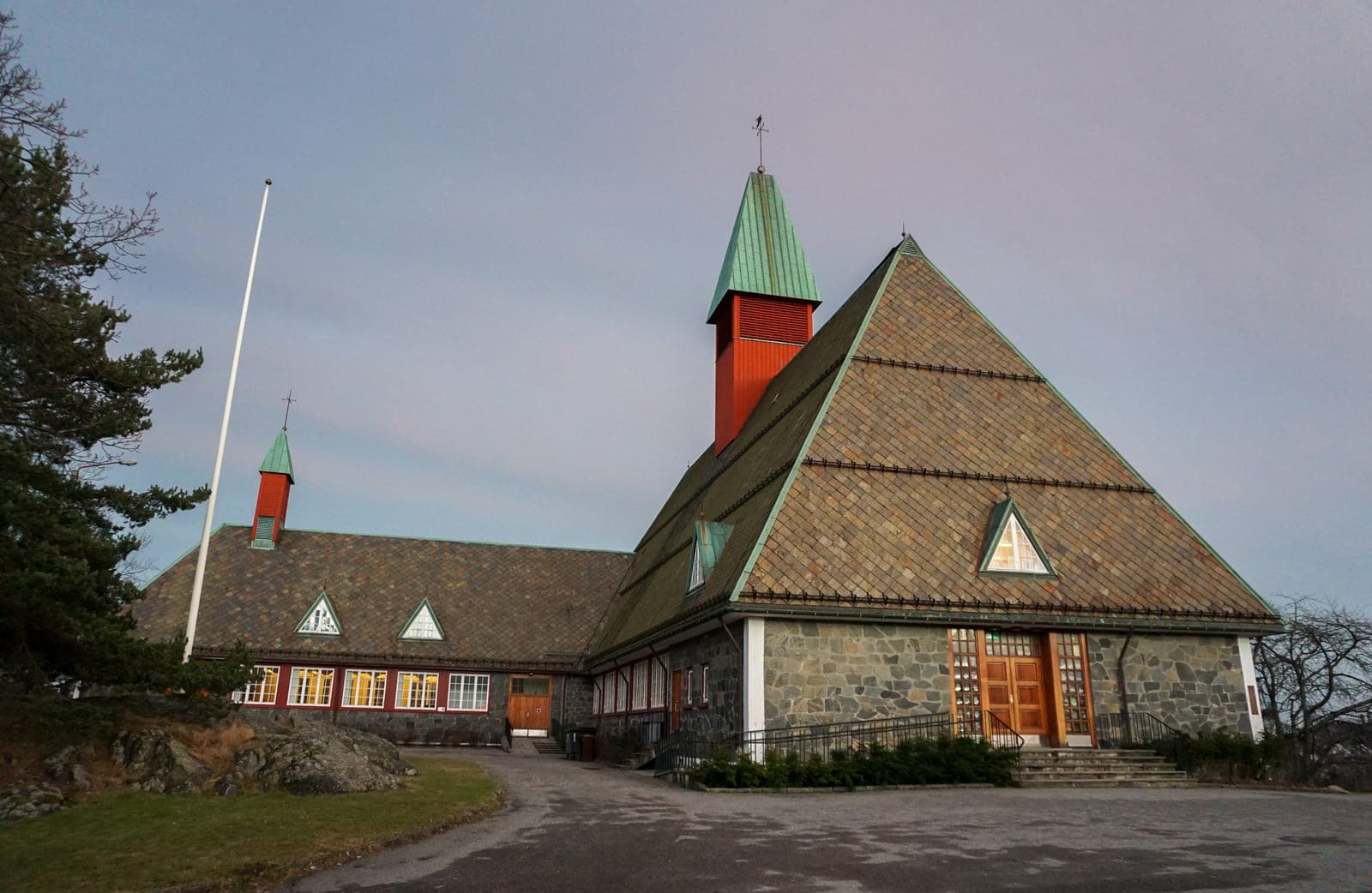 Vagsbygd church, built in 1967, with its steep shingled roof and red-capped tower, in Vagsbygd, Kristiansand.