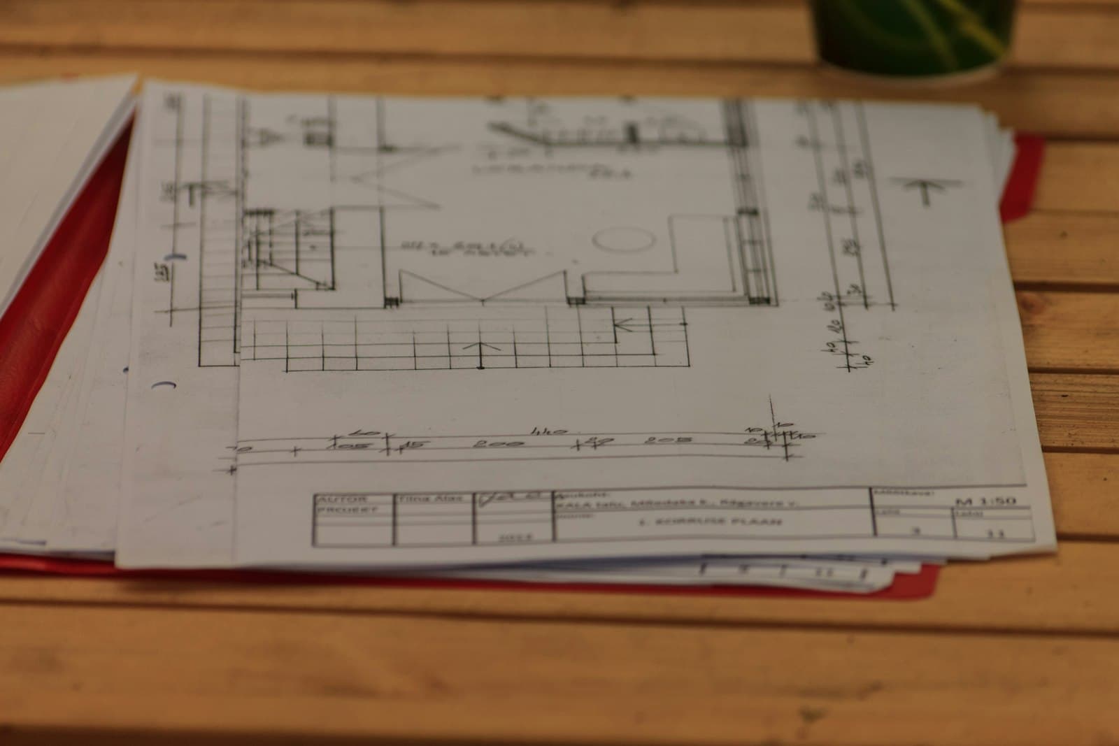 Architectural plans and drawings of a house on a desk