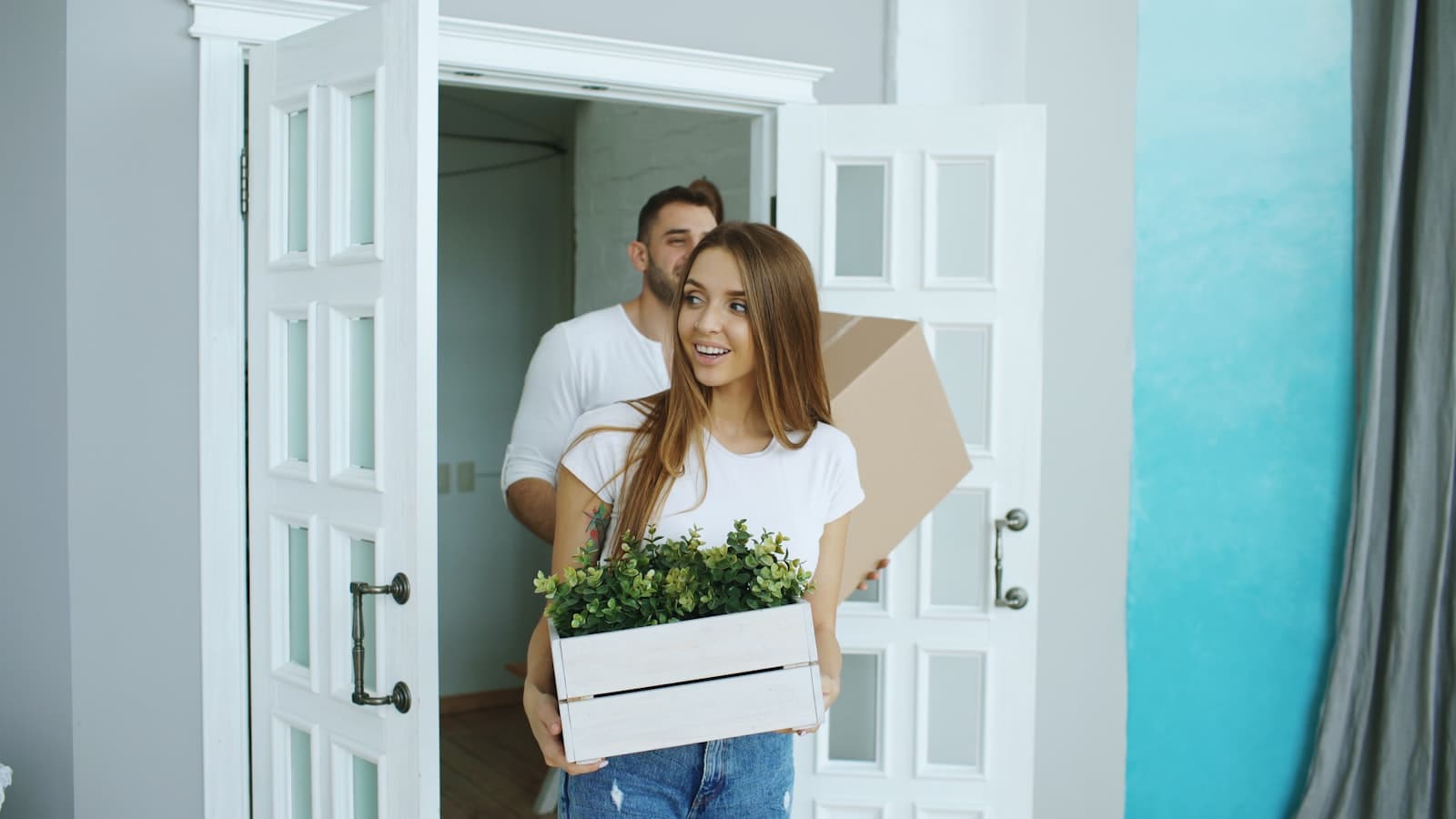 A couple standing at the front door of a home